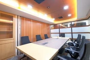 M Spaces large meeting room equipped with a long conference table and modern seating.