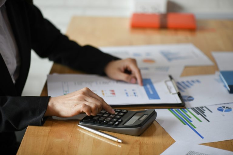 Cropped shot of Accounting staff are using calculators and graphing to pay annual taxes.