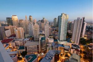 Aerial view of a bustling business district with high-rise buildings during the early evening.