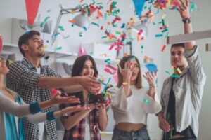 People toasting with champagne and sparklers at a celebration.