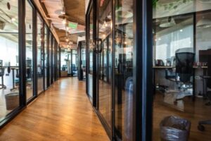 Modern office hallway with glass-walled rooms