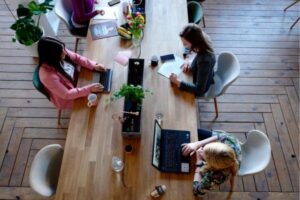 Overhead view of professionals working together at a shared table.