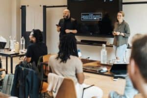 People attending a casual workshop or training session in a classroom layout