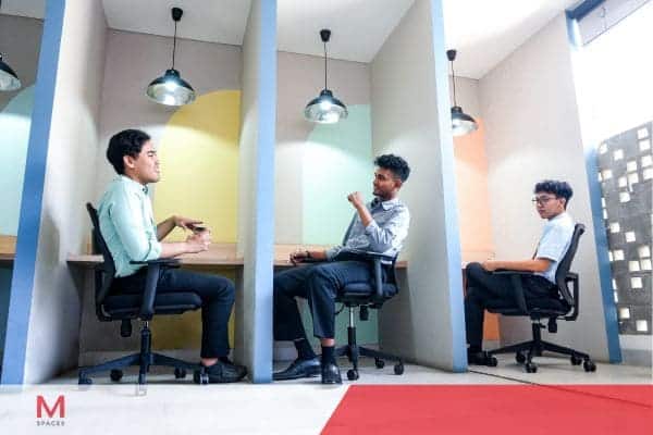 Employees working in modern office cubicles