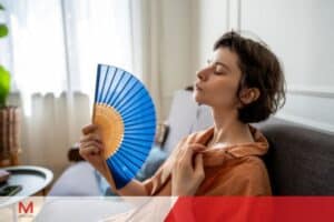 Using a fan to stay cool while working from home during the summer.