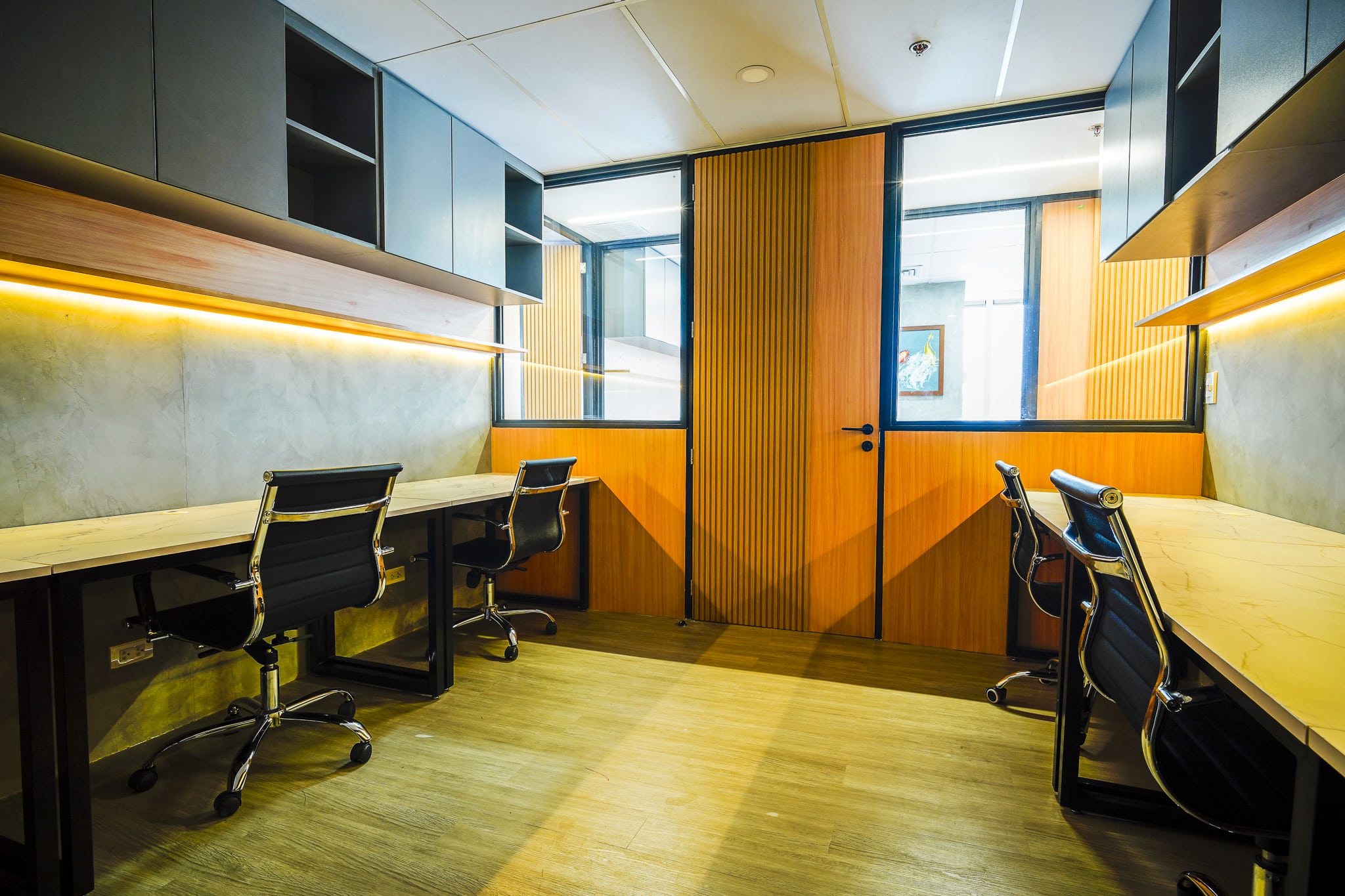 Private office workspace with individual desks and chairs
