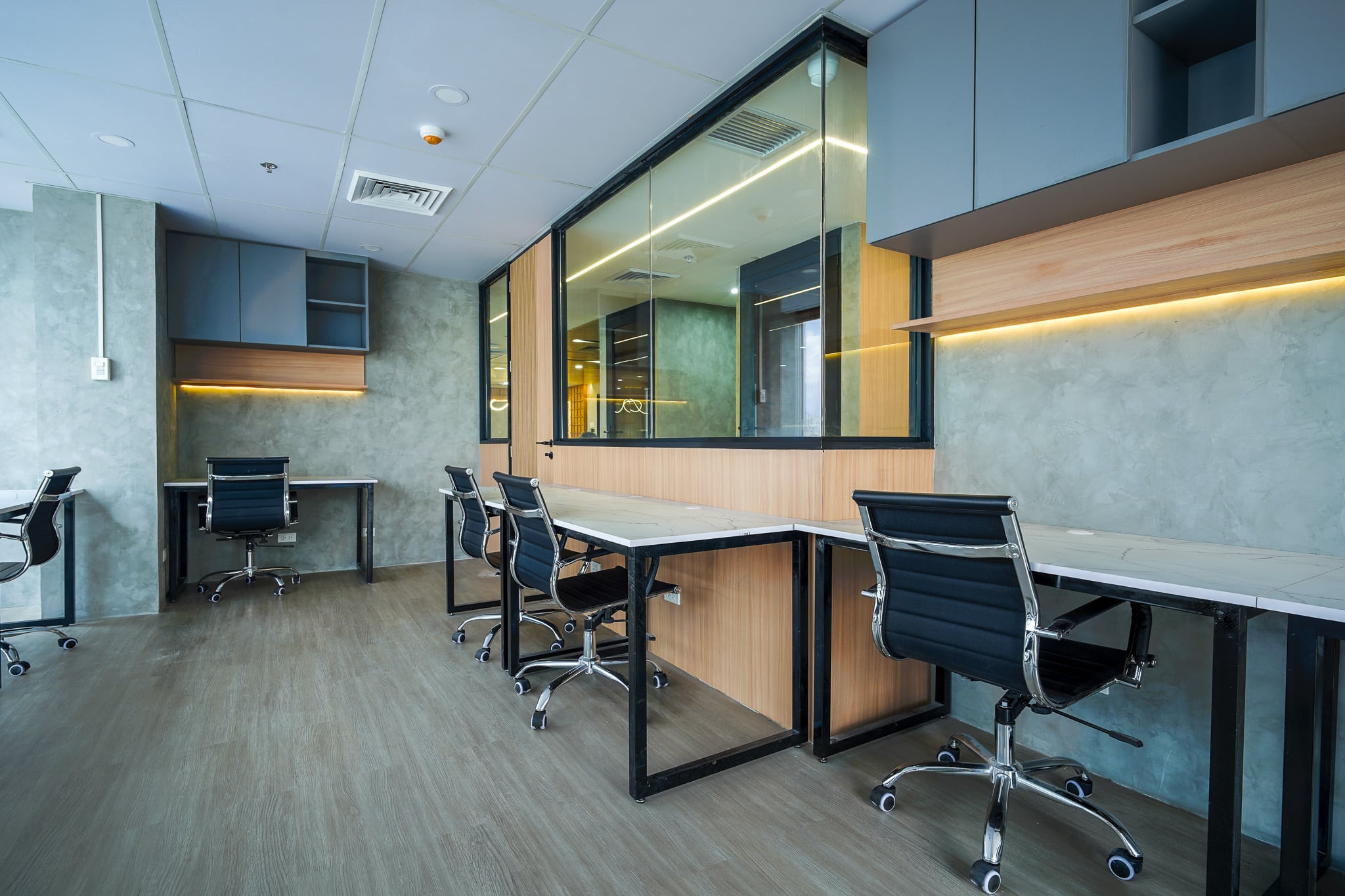 Modern shared office workspace with desks and ergonomic chairs