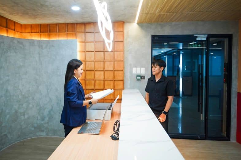 Virtual office receptionist assisting client at front desk