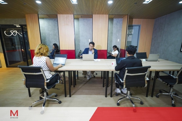 A diverse group of professionals collaborating around a conference table in a modern office setting.