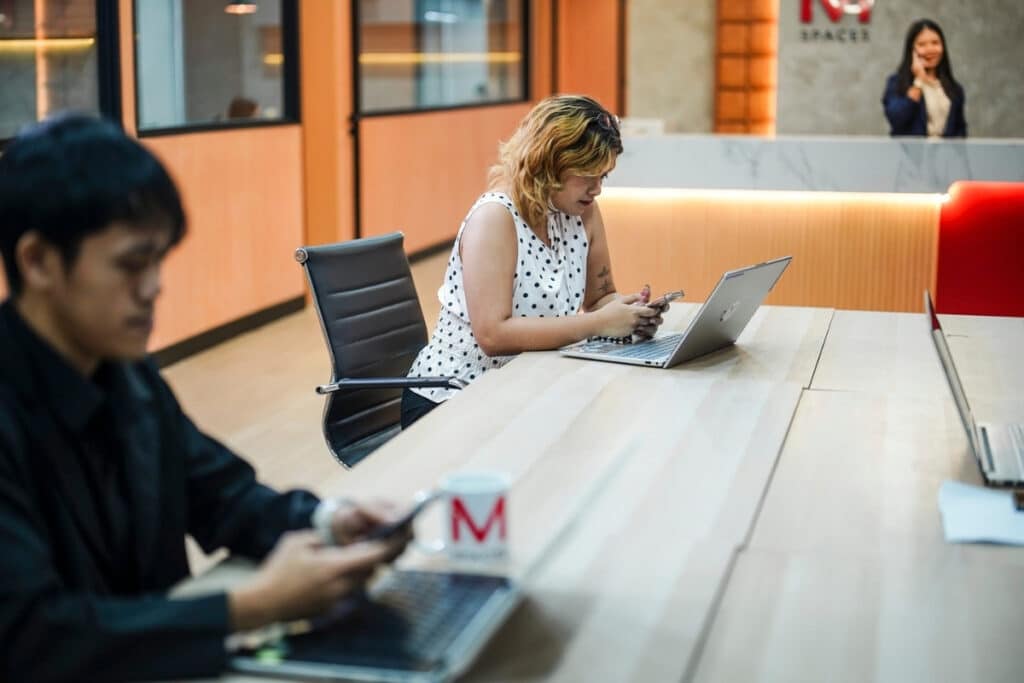 Professional working at a shared desk in M Spaces