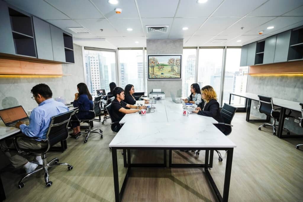 Professionals working in a shared coworking space in Makati